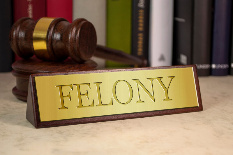 Judge gavel and name plate reading “felony” sitting on a desk. Our team of Johnson County felony lawyers know how to fight for those charged with felony crimes.