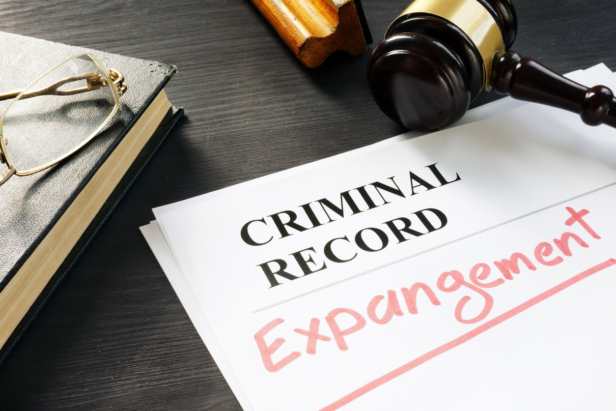 “Criminal Record Expungement” written on a paper next to a judge gavel, reading glasses, and a book. When you’re ready to put your past behind you, our team of Overland Park expungement lawyers can help you wipe your record clean.